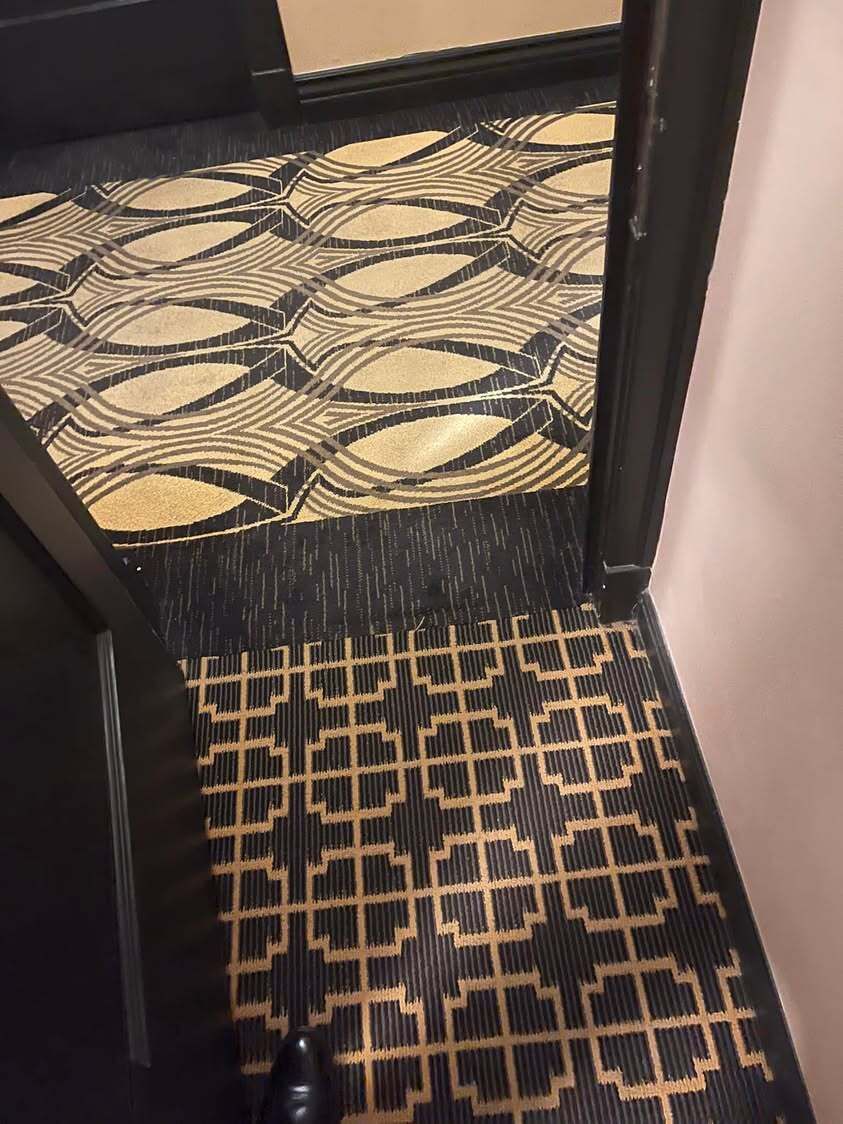 Two carpets meeting at the threshold of a room at The Peery, Salt Lake City